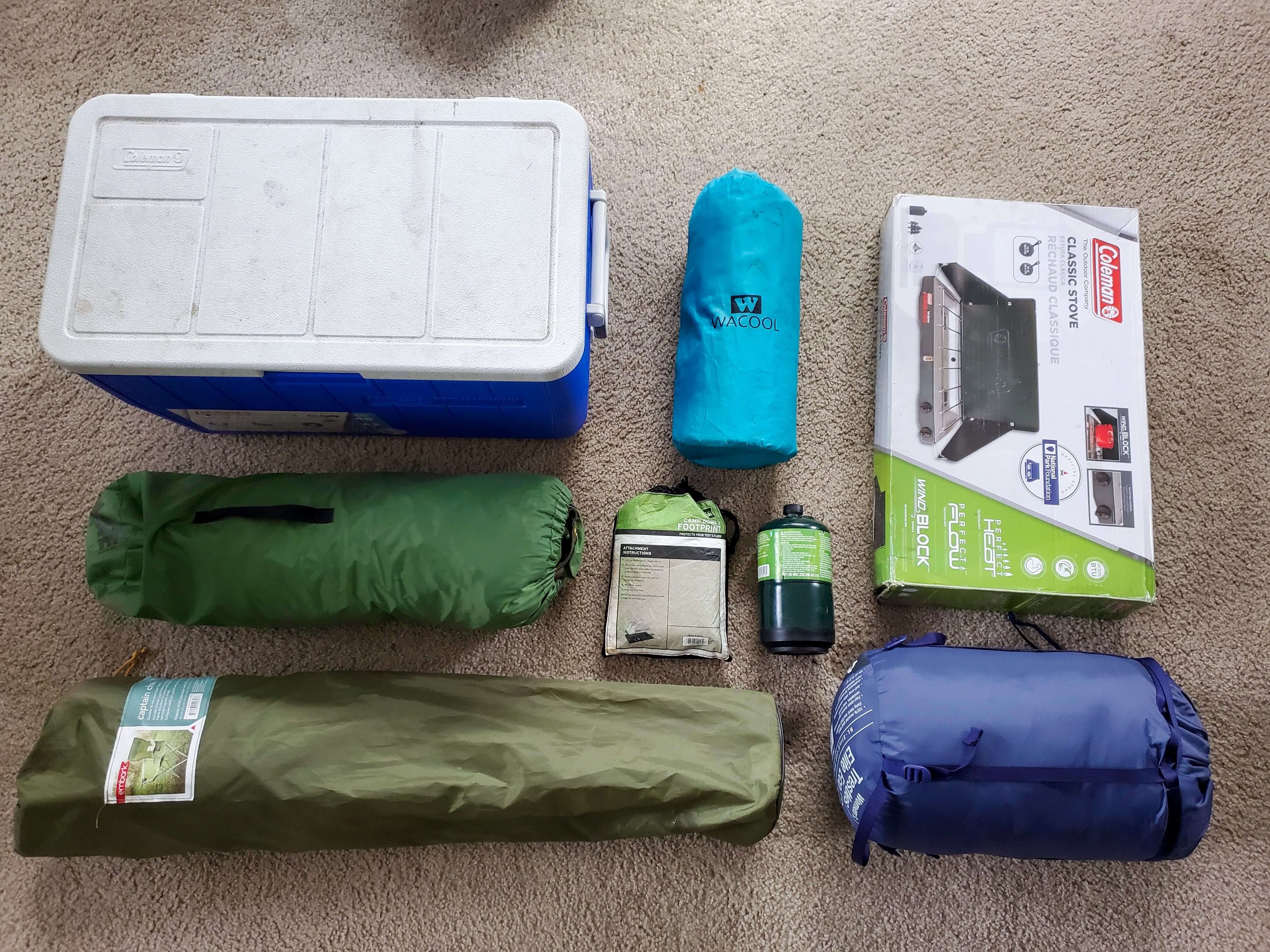 Camping gear laid out on the floor