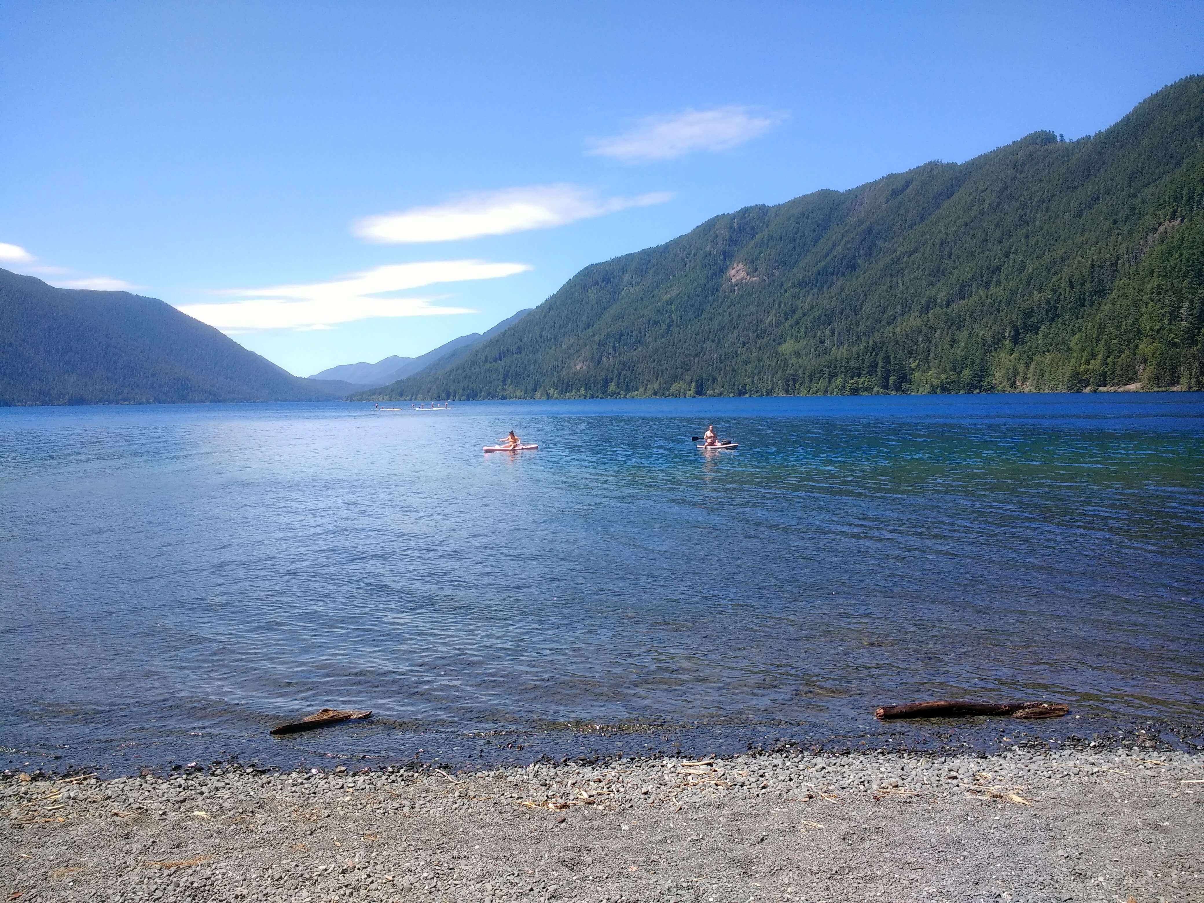 People sitting on paddleboards on Lake Crescent in Olympic National Park