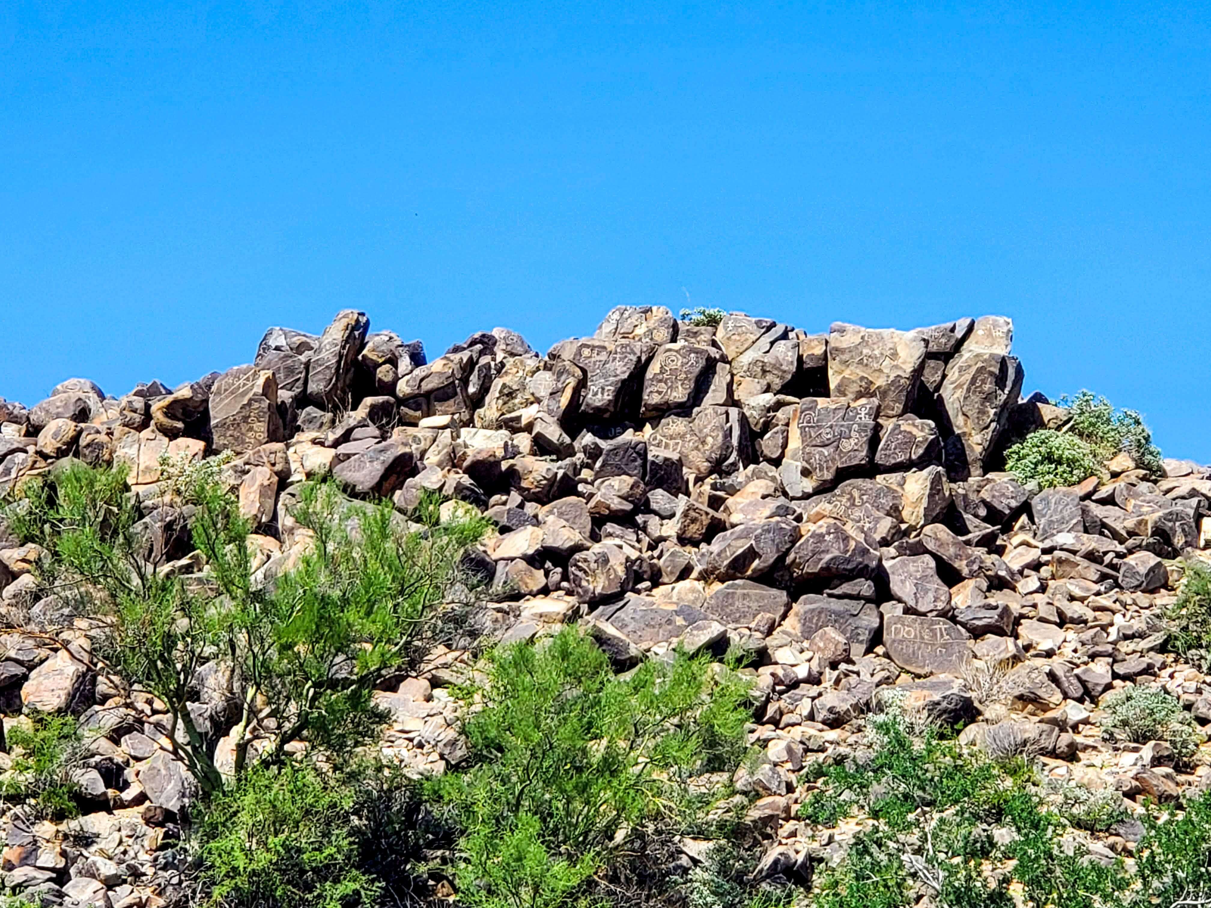 Rocks with petroglyphs under a blue sky at Signal Hill in Saguaro National Park