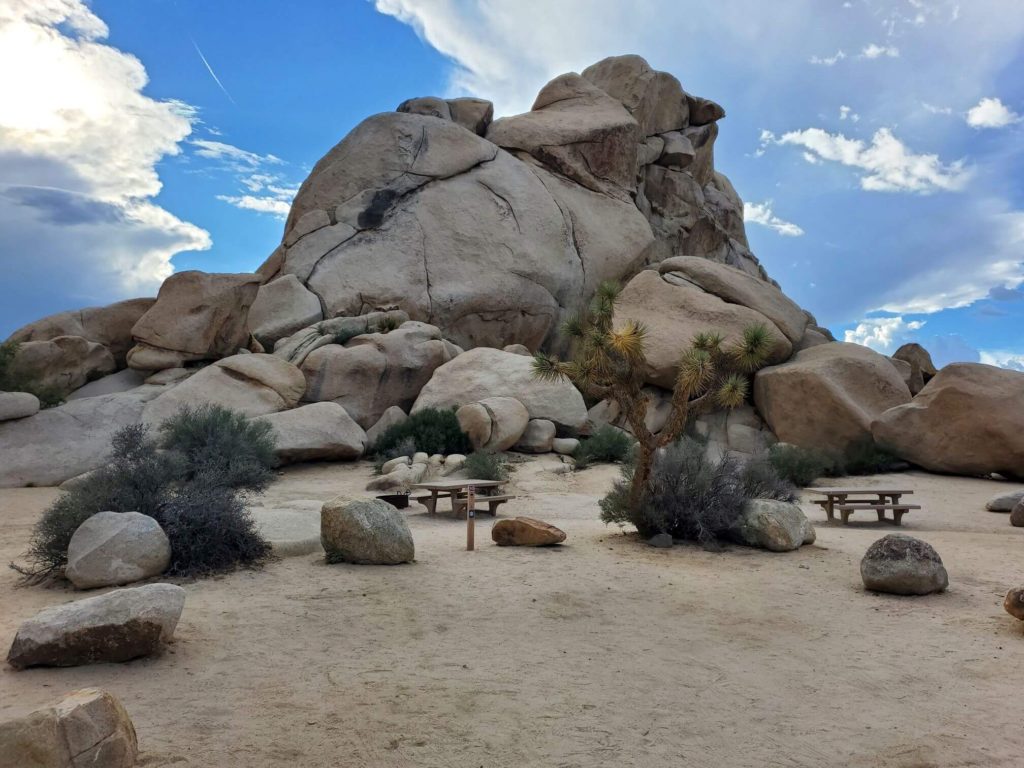 Empty campsites in front of large boulders in the desert