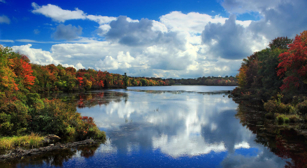 A lake surrounded by colorful autumn trees