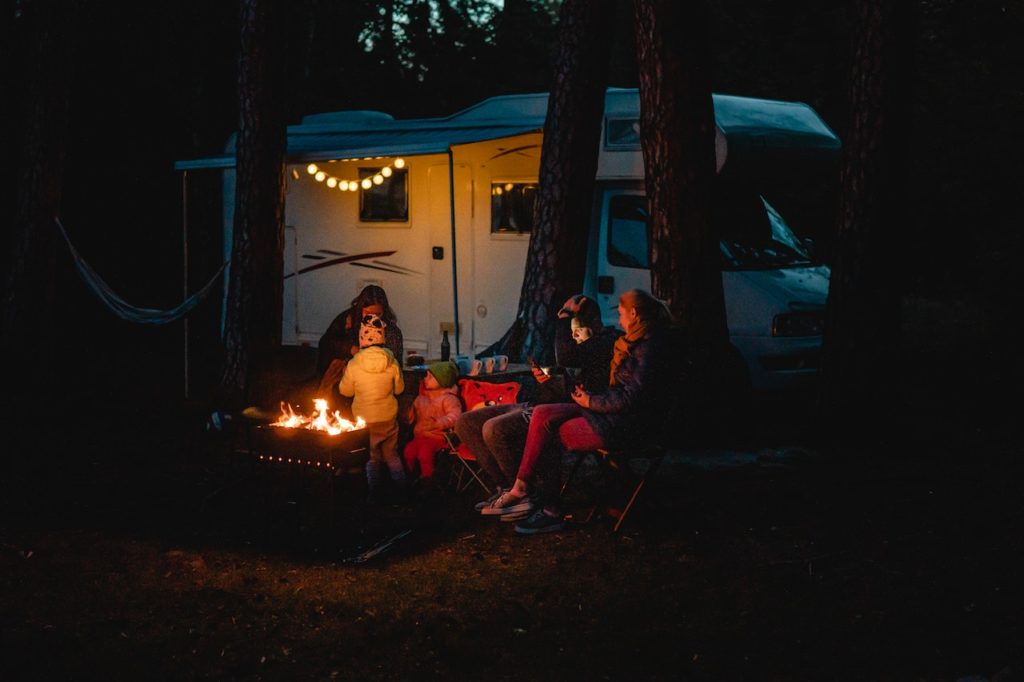 A family sitting around a campfire at night