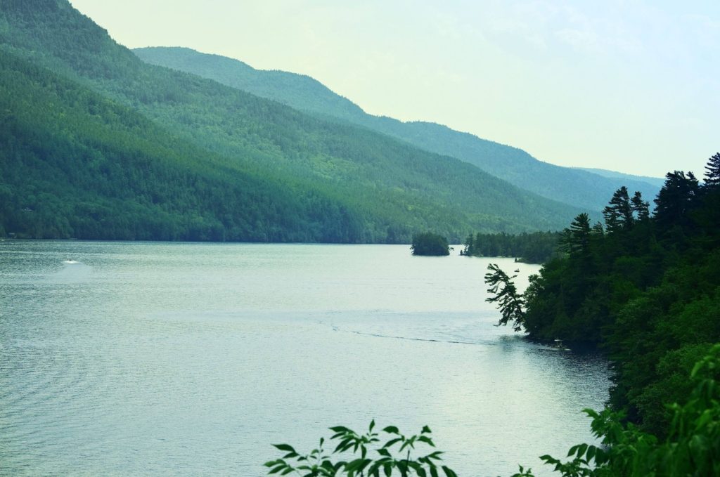 Lake George surrounded by green hills and foliage