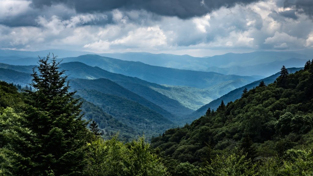 View overlooking green mountains under a cloudy sky