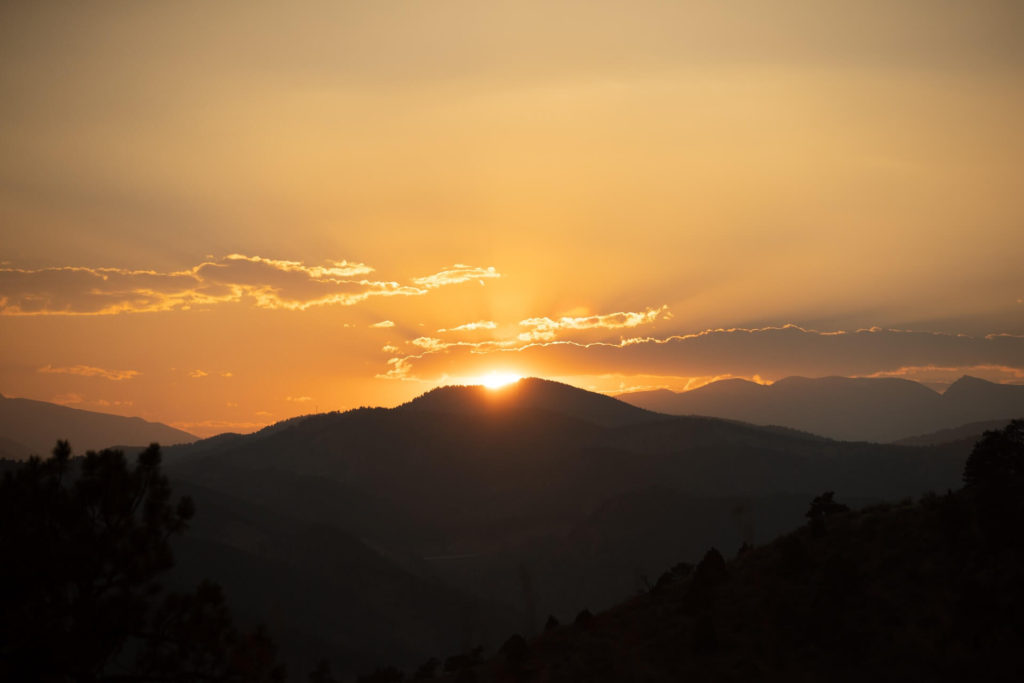 Sun beginning to rise over a mountain