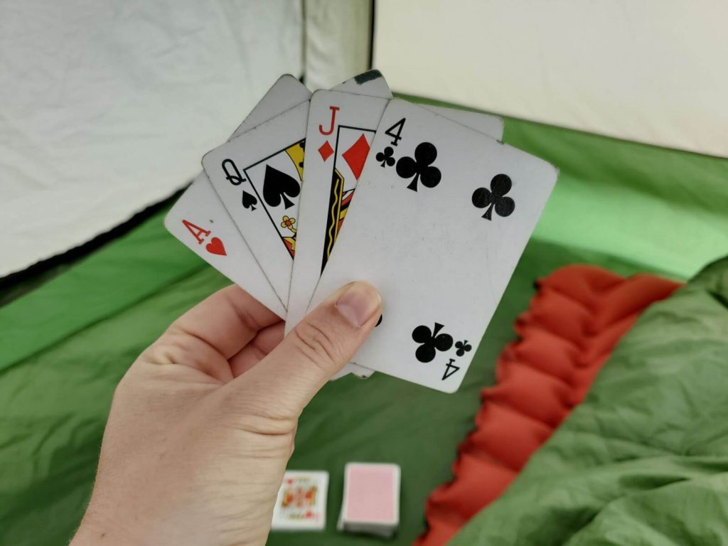 A game of cards inside a tent