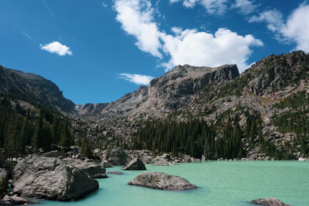 Lake Haiyaha in Rocky Mountain National Park shown with turquoise water after a rock slide turned the water from clear to a milky blue color 