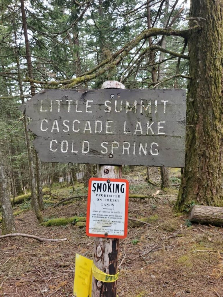Wooden trail sign for Little Summit, Cascade lake, and Cold Spring Trails on Orcas Island