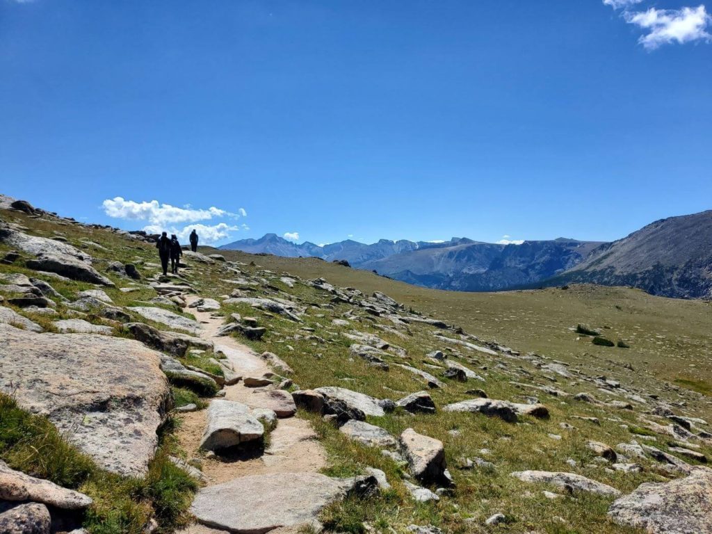 The rocky Ute Trail winds through the grassy, exposed tundra in Rocky Mountain National Park, exposing beautiful views of the surrounding mountains